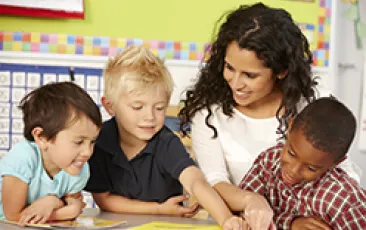 Image of teacher with happy young students