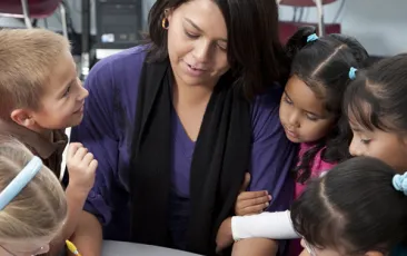 Image of teacher with young students