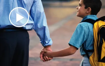 Boy and man holding hands