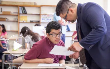 Adult leaning in to coach student
