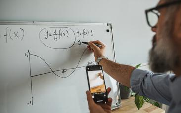 Image of man doing math on a whiteboard