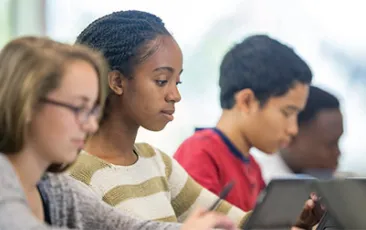 Image of high school students on laptops 