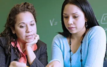 teacher and student examining a problem