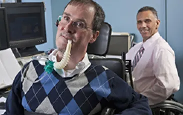 two workers with disabilities at computers