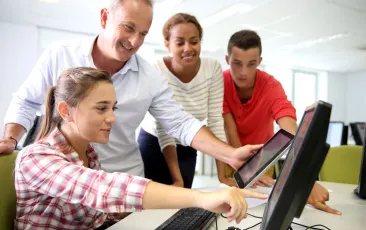 Teacher with students in computer lab