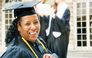 Older African American graduate in cap and gown