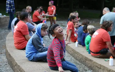Girl at SeriousFun camp smiling with other campers