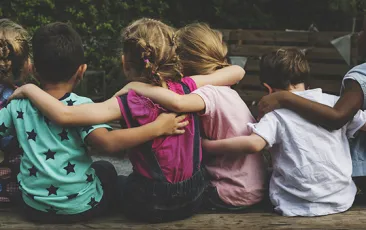 Young kids with arms around each other