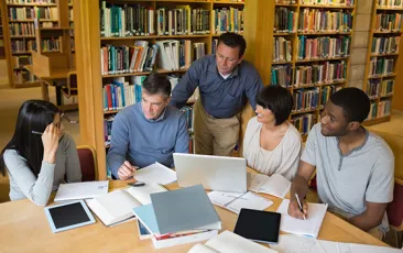 Adults working together in a library