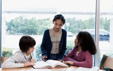 Middle school students reading together