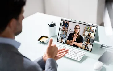 Colleagues using sign language during a virtual meeting
