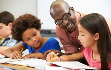 Teacher helping pupils study
