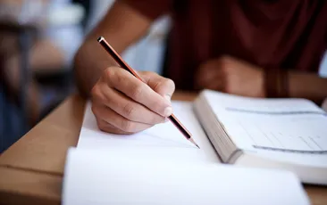 Hand and pencil taking a test