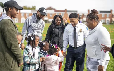 Baltimore police officer with community members