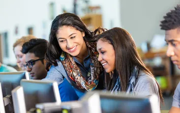 High school computer science teacher with students