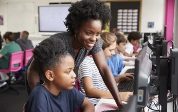 Computer science teacher with young student