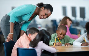 Teacher checking in on students writing
