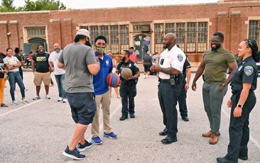 Baltimore police playing basketball with community members