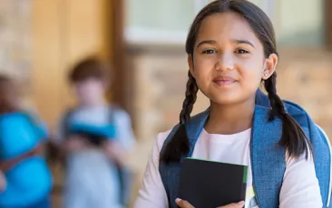 girl with backpack smiling