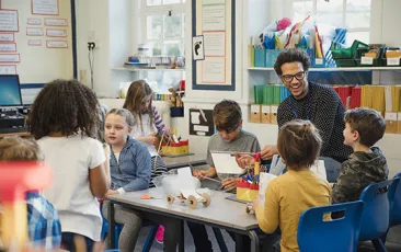 Teacher and young students in classroom