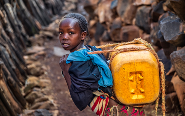 African girl carrying water from the well, Ethiopia, Africa
