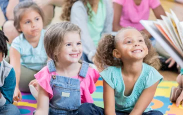 Little girls enjoy story time during after school program