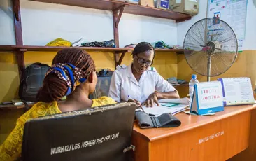 African woman at desk in health center