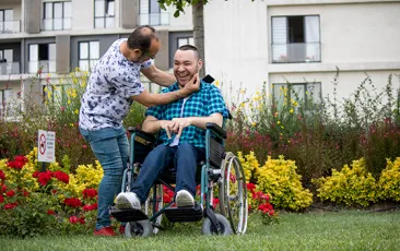 Handicapped boy spending time with his father in a wheelchair