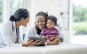 Smiling mother and child with doctor
