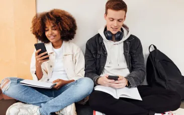 College students sitting in a hallway