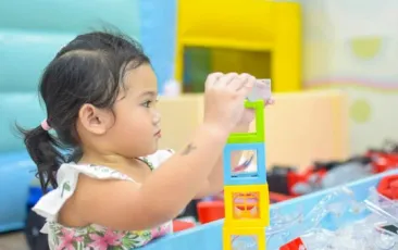 preschool girl stacking blocks
