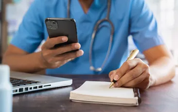 Doctor with phone and notepad