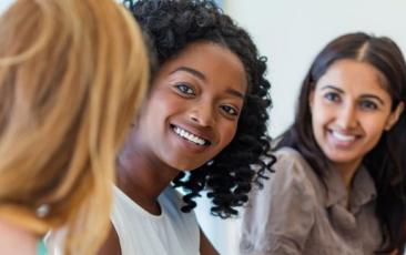 three educators talking in a classroom