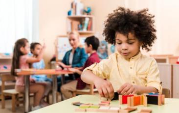 elementary student playing with blocks