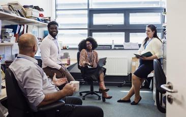 Group of colleagues talking in an office