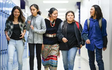 Native American students walking in school hallway