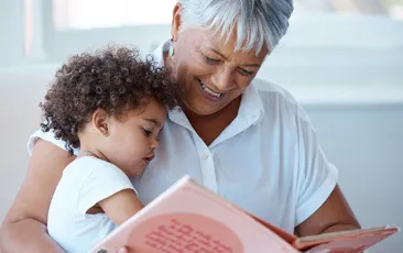 mature woman reading to small child