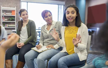teen girl talking in a group meeting