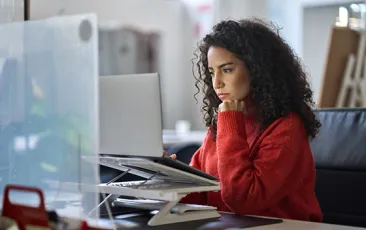 Woman looking serious at computer
