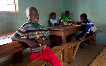 Boy smiling in Zambian classroom