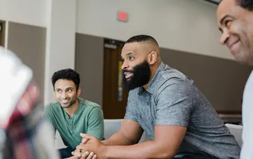 men talking in group therapy