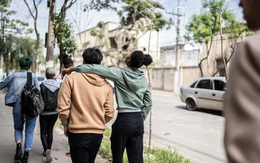 teens walking and talking in street