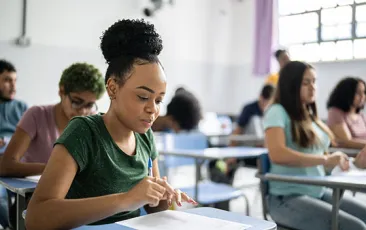 Young woman studying at classroom desk
