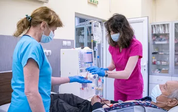 Nurses prepare patient for dialysis