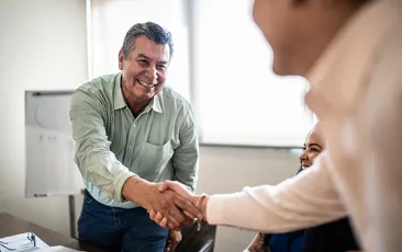 man shaking hands at job interview