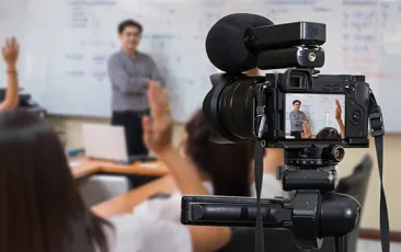 Video camera filming a teacher
