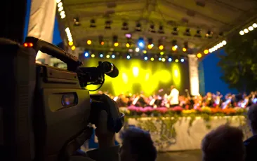 Videographer filming arts performance