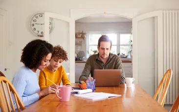 Family at home with dad on his laptop