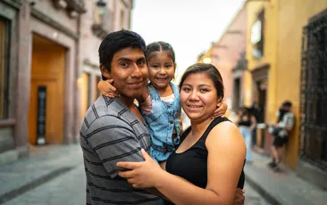 Family smiling on a street in Mexico