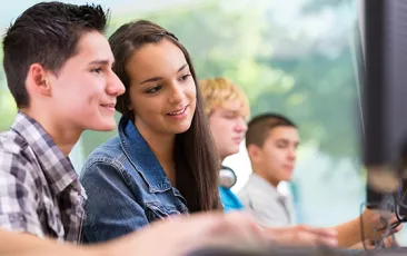 High school students working together at a desktop